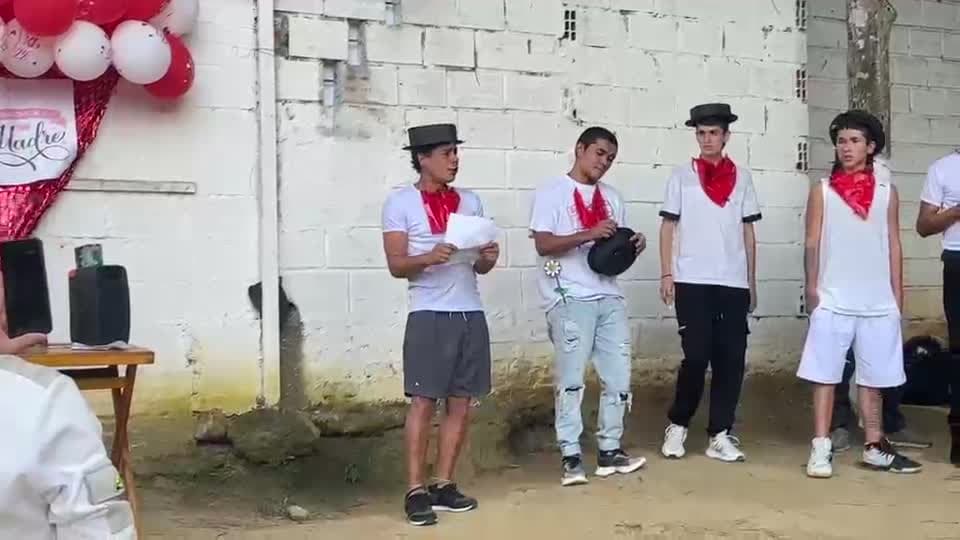 Participantes con pañuelos rojos durante una presentación comunitaria